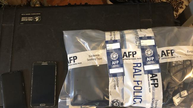 Devices seized in the arrest of Wyong man Justin Radford, 29, in February 2020 as part of an Australian Federal Police investigation into an alleged child sex abuse ring. Picture: AFP