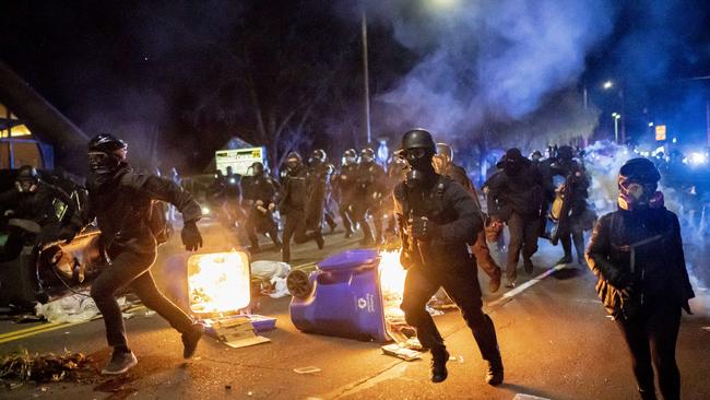 Portland police officers chase demonstrators after a riot was declared during a protest against the killing of Daunte Wright on April 12, 2021 in Portland, Oregon. Picture: AFP