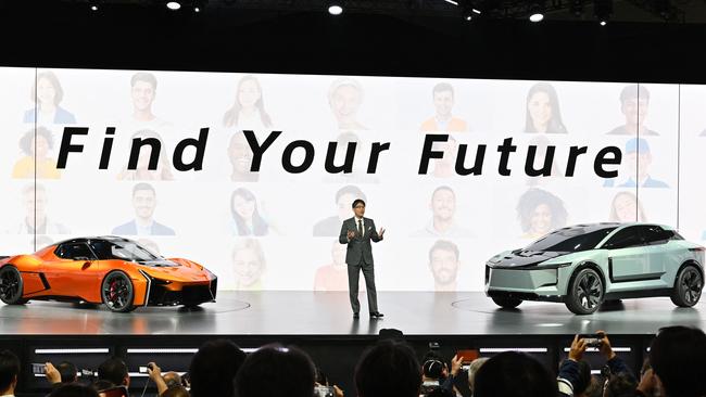 Toyota Motor President Koji Satowith sports car and SUV electric vehicle concepts. Photo: Kazuhiro NOGI / AFP