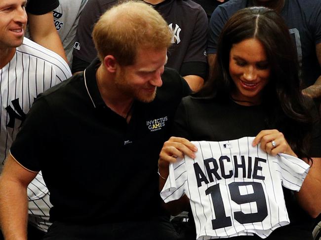 LONDON, ENGLAND - JUNE 29:   Prince Harry, Duke of Sussex and Meghan, Duchess of Sussex with a gift from the New York Yankees before their game against the  Boston Red Sox \\at London Stadium on June 29, 2019 in London, England. The game is in support of the Invictus Games Foundation. (Photo by WPA Pool/Getty Images)