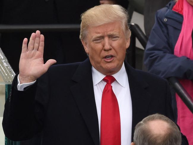 (FILES) In this file photo taken on January 20, 2017 Donald Trump (L) is sworn in as the 45th US president by Supreme Court Chief Justice John Roberts in front of the Capitol in Washington. - A New York grand jury on March 30, 2023, indicted Donald Trump over hush money payments made to a porn star during his 2016 campaign, making him the first former US president to face criminal charges. (Photo by Timothy A. CLARY / AFP)