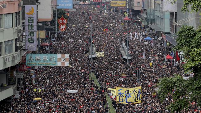 Tens of thousands of protesters march through the streets on June 16. Picture: AP/Kin Cheung