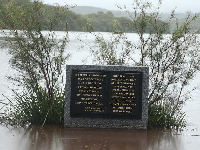 The war memorial at Manly Dam is almost completely under water. Picture: John Grainger