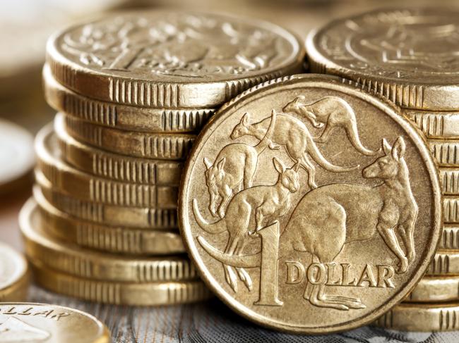 Stacks of Australian one dollar coins.  Focus on front coin. Australian cash, money generic