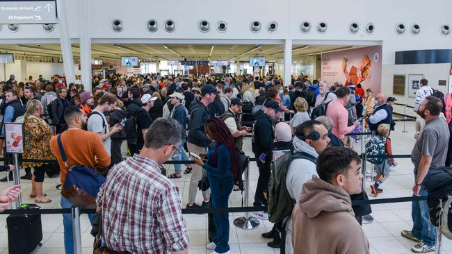 Passengers queue to be screened at Adelaide Airport after being evacuated due to a security breach in October. Picture: Brenton Edwards