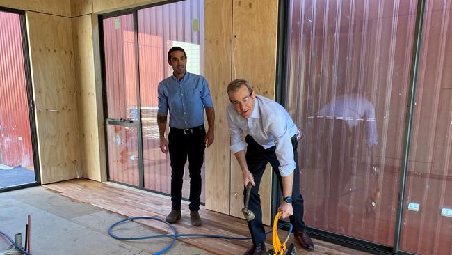 Minister for State Development, Construction and Housing Michael Ferguson inspects pods with Josh Muskett from Podmatrix in Cambridge, Tasmania on Tuesday 29 June, 2021.