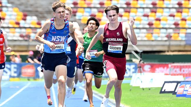 Taylor Goodwin of JPC, right, powers to a record at the Australian All Schools track and field championships in Brisbane. Picture John Gass