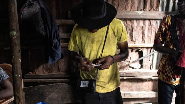 A man rolls Kush inside a drug den at the Kington landfill site in Freetown on June 21, 2023. Picture: John Wessels / AFP