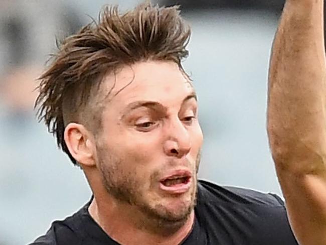 MELBOURNE, AUSTRALIA - JUNE 24:  Levi Greenwood of the Magpies is tackled by Dale Thomas of the Blues during the round 14 AFL match between the Collingwood Magpies and the Carlton Blues at Melbourne Cricket Ground on June 24, 2018 in Melbourne, Australia.  (Photo by Quinn Rooney/Getty Images)