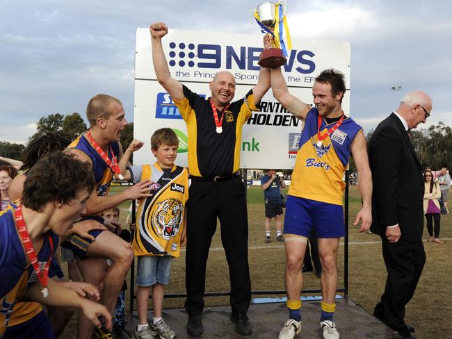 Mick Fogarty and captain Craig Anderson hoist the silverware in 2011.