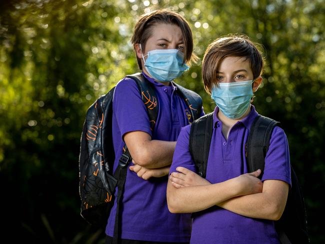 Felix, 12 and Oliver, 9 wear masks to school. Picture: Jake Nowakowski