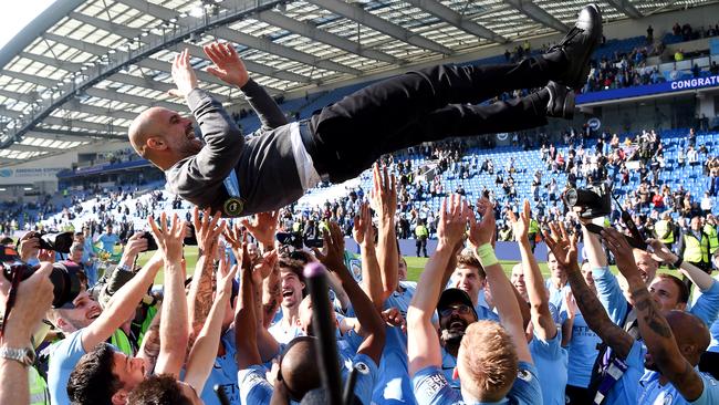 Manchester City players celebrate with manager Pep Guardiola after clinching the English Premier League title with a 4-1 over Brighton. Picture: Getty Images