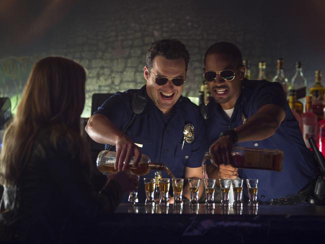 Ryan (Jake Johnson) and Justin (Damon Wayans Jr) heard to a bar dressed as LAPD officers. Picture: Supplied