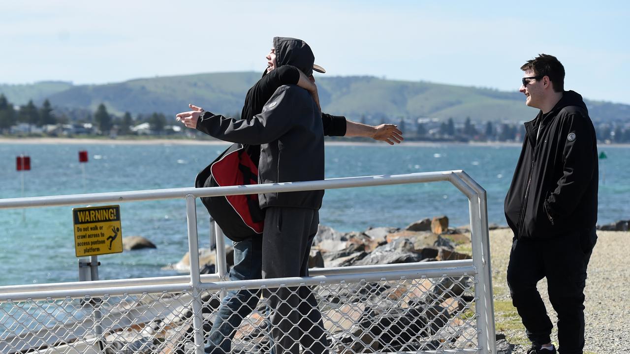 Derek Robinson is reunited with his family as he disembarks on to Granite Island. Picture: NCA NewsWire / Picture: Naomi Jellicoe