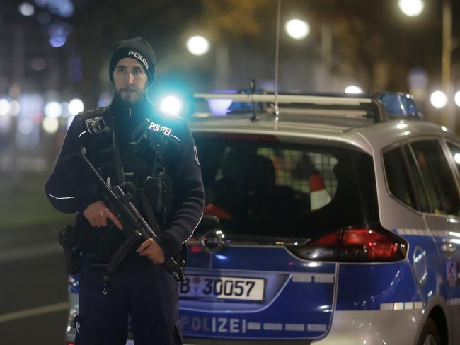 A police officer with a submachine gun stands guard after a truck ran into a crowded Christmas market in Berlin. Picture: AP