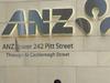This picture taken on October 30, 2014 shows a man checking his mobile phone under the Australia and New Zealand Banking Group (ANZ) sign in the central business district of Sydney. The ANZ on October 31, 2014 announced record annual net profit of 6.5 billion USD -- up 15 percent -- pursuing an Asia-focused growth strategy. AFP PHOTO / Saeed KHAN