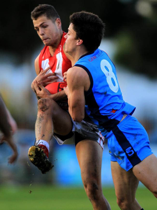 Tom Langford is tackled by Sturt’s Jack Stephens while playing for North Adelaide in 2013.