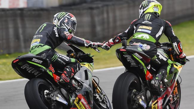 Moto GP rider Johann Marco, right, of France celebrates with teammate Jonas Folger of Germany after winning the MotoGP qualifying session ahead of the Dutch Grand Prix, in Assen, northern Netherlands, Saturday, June 24, 2017. (AP Photo/Geert Vanden Wijngaert)