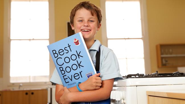 Tottenham Central School student Harry Chase, 10, pictured with the fundraising book the school came up with. Picture: Jonathan Ng