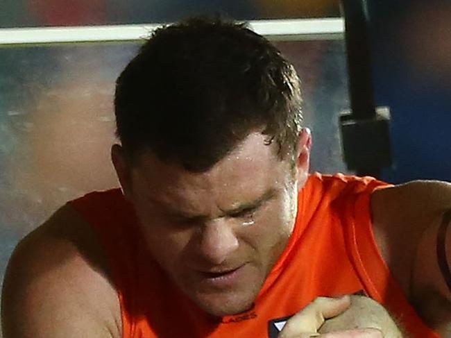 CANBERRA, AUSTRALIA - AUGUST 11:  Heath Shaw of the Giants is assisted from the field during the round 21 AFL match between the Greater Western Giants and the Adelaide Crows at UNSW Canberra Oval on August 11, 2018 in Canberra, Australia.  (Photo by Mark Nolan/Getty Images)