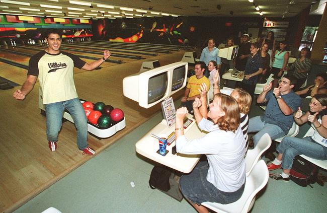 In happiere times. Richard Vogt and other collegues from the Department of Communications and Information Services celebrate his strike at Planet Tenpin in 2002.