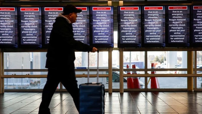 A passenger passes through Ronald Reagan Washington National Airport in the aftermath of the collision. Picture: Eduardo Munoz/Reuters/WSJ