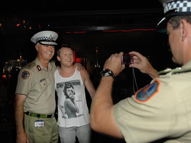 Former NT police commissioner John McRoberts in happier times mingling with revellers along Mitchell Street on New Year’s Eve in 2010 before he went to jail for attempting to pervert the course of justice. Picture: Stuart Walsmsley