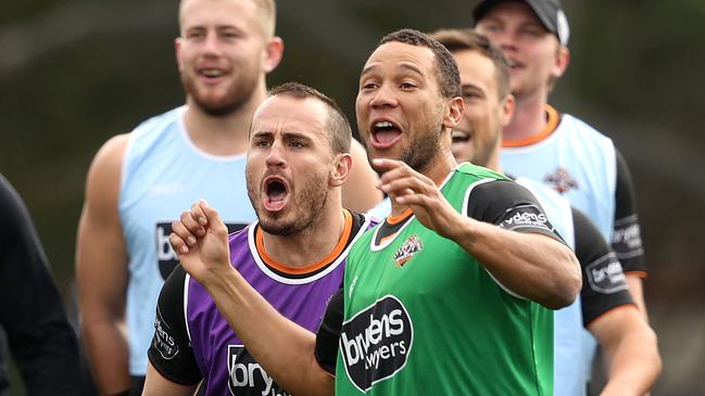 Josh Reynolds and Moses Mbye at Wests Tigers training this week. Picture: Phil Hillyard