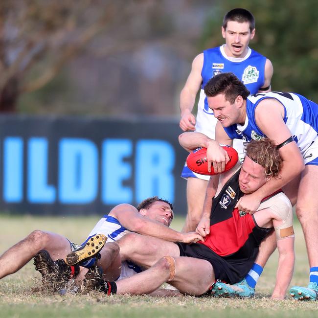 Irrewarra-Beac’s Mitchell Thornton is tackled by South Colac duo Bradley Surkitt and Zach Downard.