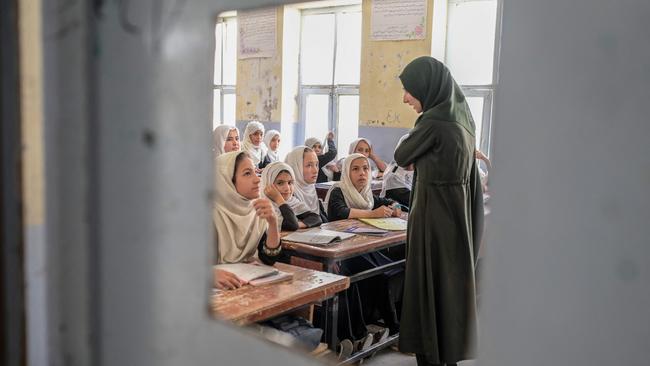 A teacher in a classroom full of girls in Kandahar. Picture: AFP