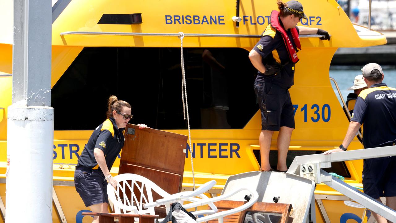 The Coast Guard return and unload what appears to be debris from the boat that capsized in Moreton Bay. Picture: Steve Pohlner