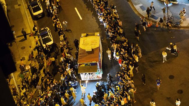 The Olympic torch is carried through the streets of Copacabana as the torch relay continues on its journey to the opening ceremony of the 2016 Summer Olympics in Rio de Janeiro, Brazil, early Friday, Aug. 5, 2016. (AP Photo/David Goldman)