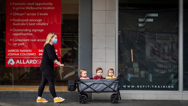 Daniella Altit keeps her 19-month-old triplets, Jackson, Amelie and Mia, close during a permitted outing for exercise in Prahran, Melbourne, on Sunday. Picture: Jake Nowakowski