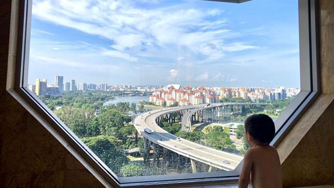 Mrs. Van Dee's son gazes out the bathroom window in their hotel room during quarantine. Picture: Joy Van Dee via The Wall Street Journal