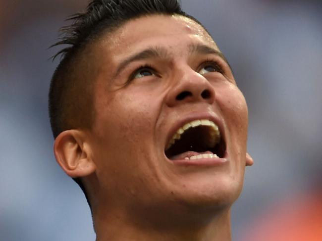 (Files) In this file picture taken on June 25, 2014, Argentina's defender Marcos Rojo celebrates his goal during a Group F football match against Nigeria at the Beira-Rio Stadium in Porto Alegre during the 2014 FIFA World Cup. A tweet published from Manchester United's official account on Tuesday evening stated that it "has reached agreement with Sporting Lisbon to sign defender Marcos Rojo, subject to a medical and personal terms". AFP PHOTO / PEDRO UGARTE