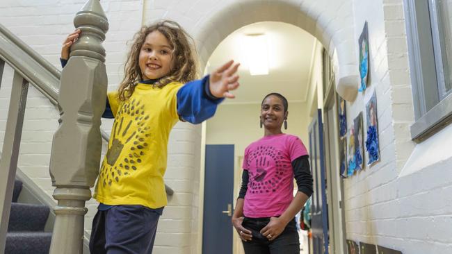 Inner west artist and art and design teacher Michelle Kistima-Menser at Ashfield Public School with student Maya Himawan wearing hand printed T-shirts that will form part of an EDGE Ashfield installation. Picture: Matthew Vasilescu