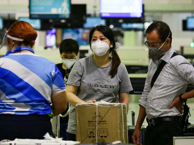 SYDNEY, AUSTRALIA - NewsWire Photos DECEMBER 21, 2020. People are seen checking in wearing face masks for an international flight to China while most of the airport remains a ghost town due to COVID-19 in Sydney Australia. Picture: NCA NewsWire / Gaye Gerard