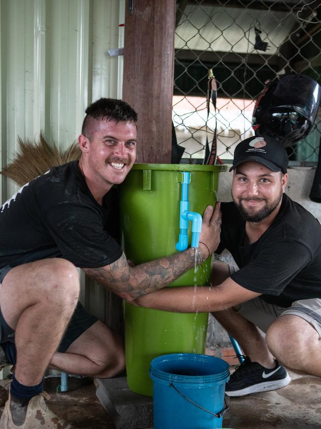 Reece Foundation volunteers Kale McCain and Carl Bushby testing the water flow rate of one of the new BioSand filters to ensure it is working correctly. Picture: Supplied