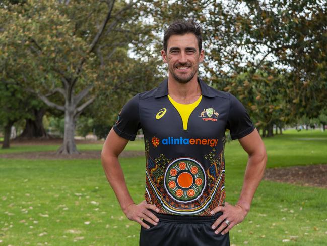 Mitchell Starc shows off the Indigenous playing shirt the Australians will wear in the T20 international series against India.