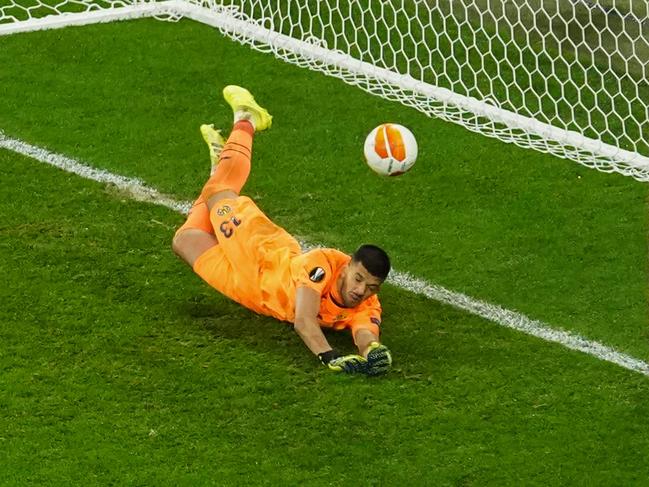 Villarreal's Argentine goalkeeper Geronimo Rulli deflects a shot by Manchester United's Spanish goalkeeper David de Gea. The difference between agony and ecstasy.