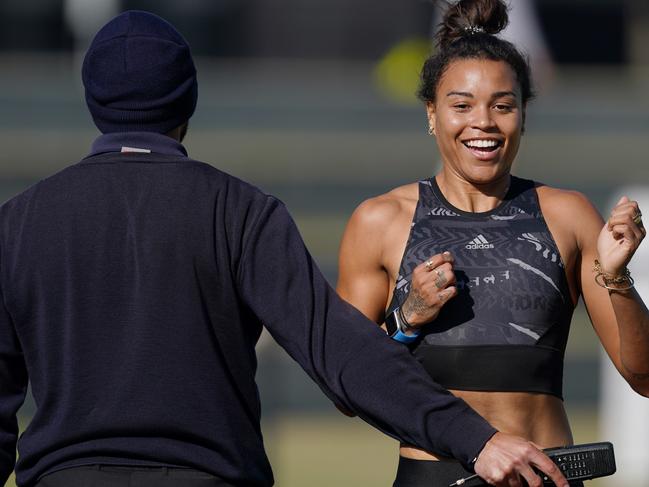 Australian sprinter Morgan Mitchell is stopped by a security guard after trying to run on the ground at The Holden Centre during Magpies training in Melbourne, Monday, May 18, 2020. All AFL clubs have resumed training at their home bases today. (AAP Image/Michael Dodge) NO ARCHIVING