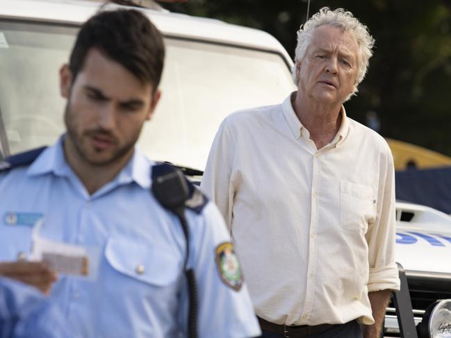 John (Shane Withington) looks on as new cop Cash Newman (Nick Cartwright) investigates the body which has washed up on Summer Bay. Picture: Channel 7