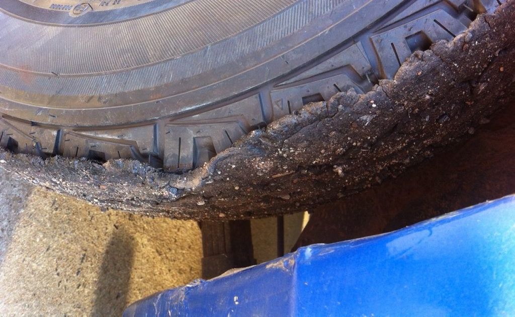 A thick layer of tar covers a car&#39;s tyres after driving between Jondaryan and Dalby. Picture: Contributed