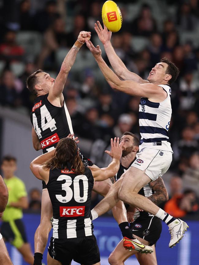 Jeremy Cameron of the Cats tries to mark running with the flight. Picture: Michael Klein