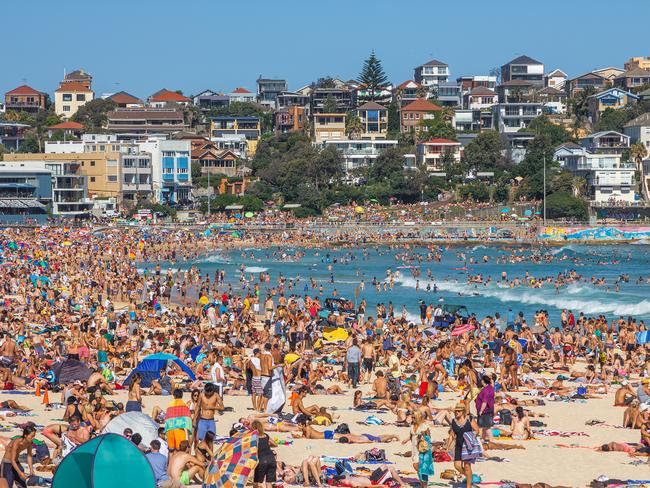 Very crowded but immensely popular Bondi Beach in Sydney. Thousands of sun lovers will gather here to swim and surf on any sunny day, tourists and locals alike.