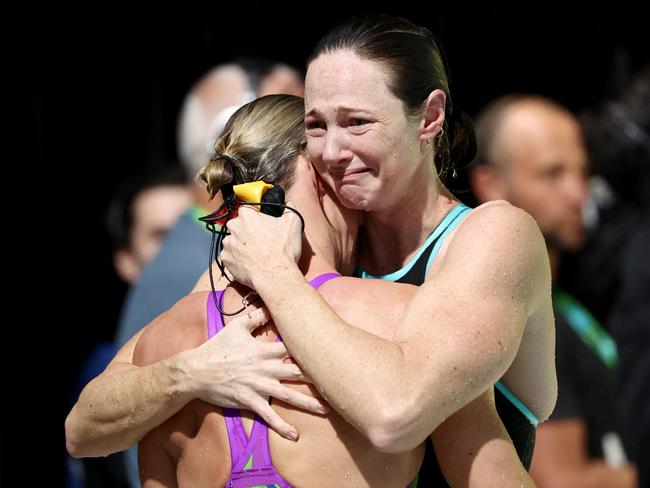 Cate Campbell (right) hugs sister Bronte Campbell after the women’s 50m freestyle heats at the Australian Swimming Trials. Picture: AFP