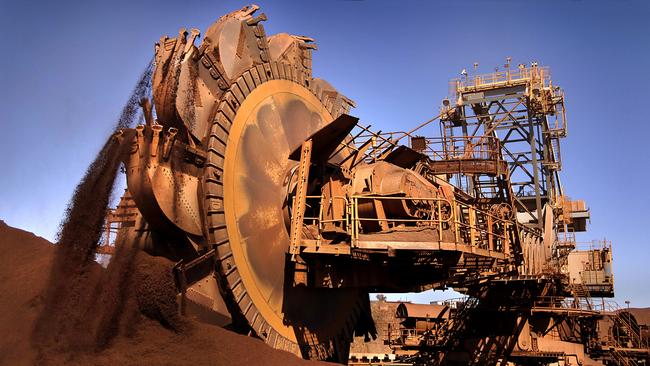 A Rio Tinto bucket wheel reclaimer shovels iron ore at Karatha Port in north Western Australia. Picture: Bloomberg