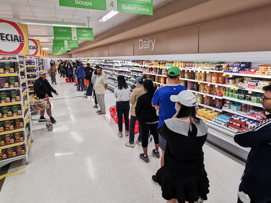 Once inside the store, people had to queue if they wanted toilet paper, paper towel and pasta. Picture: AAP/James Gourley