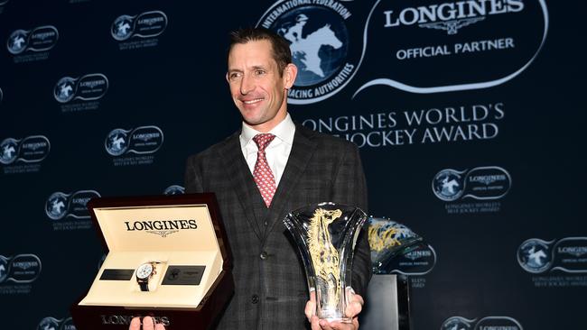 Hugh Bowman poses with trophy and watch after being awarded 2017 Longines World's Best Jockey Award. Picture: Getty.