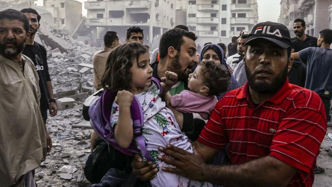 People carry children as they flee, following an Israeli strike on Rafah in the southern Gaza Strip. Picture: AFP